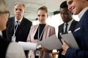 Business professionals reviewing documents in meeting